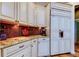 Custom kitchen featuring cream-colored cabinetry, granite countertops, and decorative tile backsplash at 15302 Lake Maurine Dr, Odessa, FL 33556