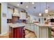 Open kitchen features a center island, granite countertops, and flows into the living area at 15302 Lake Maurine Dr, Odessa, FL 33556
