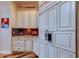 Custom kitchen featuring cream-colored cabinetry, granite countertops, and stainless steel refrigerator at 15302 Lake Maurine Dr, Odessa, FL 33556