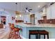 Modern kitchen with a large island, granite countertops, and stainless steel appliances at 15302 Lake Maurine Dr, Odessa, FL 33556