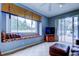 Cozy living room features a window seat with cushions and sliding glass doors to the outdoor pool area at 15302 Lake Maurine Dr, Odessa, FL 33556