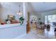 Open-concept living area with dining room and living room featuring travertine floors and an archway at 15302 Lake Maurine Dr, Odessa, FL 33556
