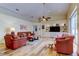 Spacious living room with hardwood floors, built-in shelving, and ample natural light at 15302 Lake Maurine Dr, Odessa, FL 33556
