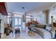 Open-concept living area featuring travertine floors, decorative columns, and fireplace at 15302 Lake Maurine Dr, Odessa, FL 33556