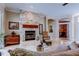 Bright and airy living room featuring a stone fireplace, plush seating, and open layout at 15302 Lake Maurine Dr, Odessa, FL 33556
