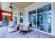 Covered patio featuring a ceiling fan, stacked stone gas fire pit and an outdoor kitchen at 15302 Lake Maurine Dr, Odessa, FL 33556