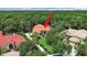 Aerial view of a gorgeous home surrounded by lush greenery and a red arrow pointing towards the property at 16343 Burniston Dr, Tampa, FL 33647