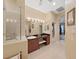Well-lit bathroom with glass-enclosed shower, single vanity, and neutral tones creating a spa-like atmosphere at 16343 Burniston Dr, Tampa, FL 33647