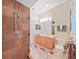 Shower with tiled walls and a chrome shower head, paired with a sleek vanity at 16343 Burniston Dr, Tampa, FL 33647