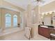 Luxury bathroom featuring a soaking tub, glass shower, and vanity with ample counter space at 16343 Burniston Dr, Tampa, FL 33647