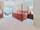Spacious primary bedroom featuring a seating area and a large four-poster bed at 16343 Burniston Dr, Tampa, FL 33647