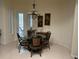 Cozy breakfast nook with glass table, wicker chairs, and view to the outdoor patio at 16343 Burniston Dr, Tampa, FL 33647