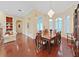 Formal dining room featuring a chandelier, wood floors, and lots of natural light at 16343 Burniston Dr, Tampa, FL 33647