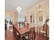 Elegant dining room featuring a large wooden table, chandelier, and seamless transition to other living areas at 16343 Burniston Dr, Tampa, FL 33647