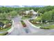 Community entrance features brick signage, manicured landscaping, palm trees, and a roundabout to the beautiful clubhouse at 16343 Burniston Dr, Tampa, FL 33647