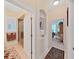 Hallway view leading to a bathroom with a glass shower, with neutral tones creating a cohesive design at 16343 Burniston Dr, Tampa, FL 33647