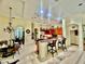 Spacious kitchen with bar, granite countertops, wooden cabinets, and dining area at 16343 Burniston Dr, Tampa, FL 33647