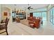 Bright living room featuring a custom entertainment center, tile flooring, and access to the lanai at 16343 Burniston Dr, Tampa, FL 33647