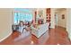 Inviting living room with fireplace, built-in shelves, wood floors, and view of the screened pool area at 16343 Burniston Dr, Tampa, FL 33647