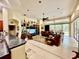 Open-plan living room featuring a decorative ceiling fan and sliding glass doors at 16343 Burniston Dr, Tampa, FL 33647