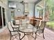 This outdoor kitchen boasts stainless steel appliances, tile backsplash, and a dining area for elegant outdoor entertaining at 16343 Burniston Dr, Tampa, FL 33647