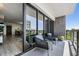 Relaxing balcony with comfortable seating and expansive windows offering natural light and a peek at the dining room at 199 Dali Blvd # 403, St Petersburg, FL 33701