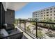 Spacious balcony with seating, featuring glass railings offering unobstructed views of the surrounding neighborhood at 199 Dali Blvd # 403, St Petersburg, FL 33701