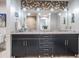 Stylish bathroom featuring double sinks, granite countertops, and decorative lighting above a dark wood vanity at 199 Dali Blvd # 403, St Petersburg, FL 33701