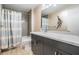 Well-lit bathroom features a shower/tub combo, gray vanity with granite countertops, and modern fixtures at 199 Dali Blvd # 403, St Petersburg, FL 33701