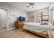 Bedroom with ceiling fan, wood-look flooring, and large window at 199 Dali Blvd # 403, St Petersburg, FL 33701