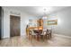 Cozy dining area featuring a wooden dining table, modern chairs, and neutral decor with wood-look tile flooring at 199 Dali Blvd # 403, St Petersburg, FL 33701