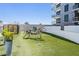Dog park with lush artificial grass, unique metal art, and walking path at 199 Dali Blvd # 403, St Petersburg, FL 33701