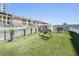Dog park with lush artificial grass, unique metal art, and walking path at 199 Dali Blvd # 403, St Petersburg, FL 33701