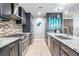 Spacious kitchen showcases a range, stainless appliances, granite countertops, and mosaic backsplash at 199 Dali Blvd # 403, St Petersburg, FL 33701