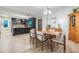 Stylish kitchen and dining area with black cabinets, modern lighting, and a dining table for entertaining at 199 Dali Blvd # 403, St Petersburg, FL 33701