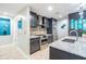 Well-lit kitchen with stainless steel appliances and stylish mosaic backsplash at 199 Dali Blvd # 403, St Petersburg, FL 33701