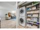 Laundry room showcases stackable washer/dryer and built-in shelving for storage at 199 Dali Blvd # 403, St Petersburg, FL 33701