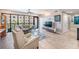 Bright living room with expansive windows, wood-look tile flooring, and modern furnishings at 199 Dali Blvd # 403, St Petersburg, FL 33701