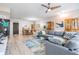 Bright open-concept living space featuring wood-look tile, comfortable seating and dining area with modern finishes at 199 Dali Blvd # 403, St Petersburg, FL 33701