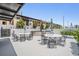 Outdoor lounge featuring tables, chairs, umbrellas, and a stainless steel grill at 199 Dali Blvd # 403, St Petersburg, FL 33701