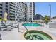 Community pool with lounge chairs, umbrellas, and a hot tub at 199 Dali Blvd # 403, St Petersburg, FL 33701