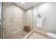 Modern tiled shower with glass door and wood bench, complemented by sleek fixtures in a well-lit bathroom at 199 Dali Blvd # 403, St Petersburg, FL 33701