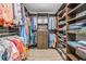 Spacious walk-in closet with wood shelving and drawers, offering ample storage for clothes and accessories at 199 Dali Blvd # 403, St Petersburg, FL 33701