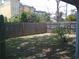 Large fenced backyard with green grass and mature trees at 212 Driftwood Pl, Palm Harbor, FL 34683