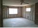 Spacious bedroom showing stud framing and windows, ready for renovation and personalization at 212 Driftwood Pl, Palm Harbor, FL 34683