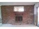 Classic brick fireplace featuring a mantle and mirror, adding a touch of rustic charm to the room at 212 Driftwood Pl, Palm Harbor, FL 34683