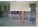 Renovation view of an open-concept living room showing stud framing in need of remodeling and repair at 212 Driftwood Pl, Palm Harbor, FL 34683