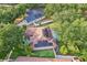 Aerial view of a home with solar panels, a screened-in pool, and a lush backyard at 2222 Longmore Cir, Valrico, FL 33596