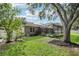 Lush backyard featuring a screened in pool area, privacy fence and beautiful landscaping at 2222 Longmore Cir, Valrico, FL 33596