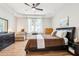 Bedroom with a queen-sized bed, side tables, dresser, and hardwood floors at 2222 Longmore Cir, Valrico, FL 33596